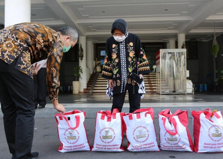 Wali Kota Surabaya Tri Rismaharini menerima bantuan sembako secara simbolis dari Presiden Joko Widodo.