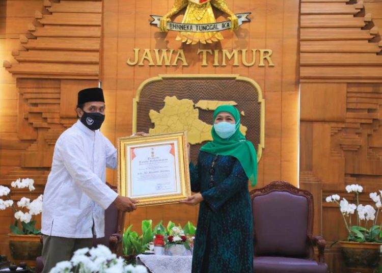 Gubernur Jatim Khofifah Indar Parawansa saat menyerahkan penghargaan Jer Basuki Mawa Beya Emas.