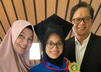Jasmine Athifa Azzahra diapit kedua orang tuanya saat berfoto  seusai mengikuti prosesi Wisuda ke-124 ITS.