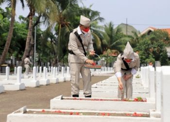 Wali Kota Surabaya, Eri Cahyadi bersama istrinya Rini Indriyani menabur bunga di salah satu makam pahlawan di TMP Kusuma Bangsa.