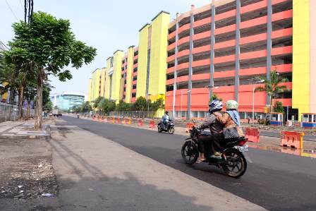 Beberapa pengendara sepeda motor dengan background gedung Pasar Turi Baru. Nantinya akan dibangun saluran air, pedestrian dan halte bus.