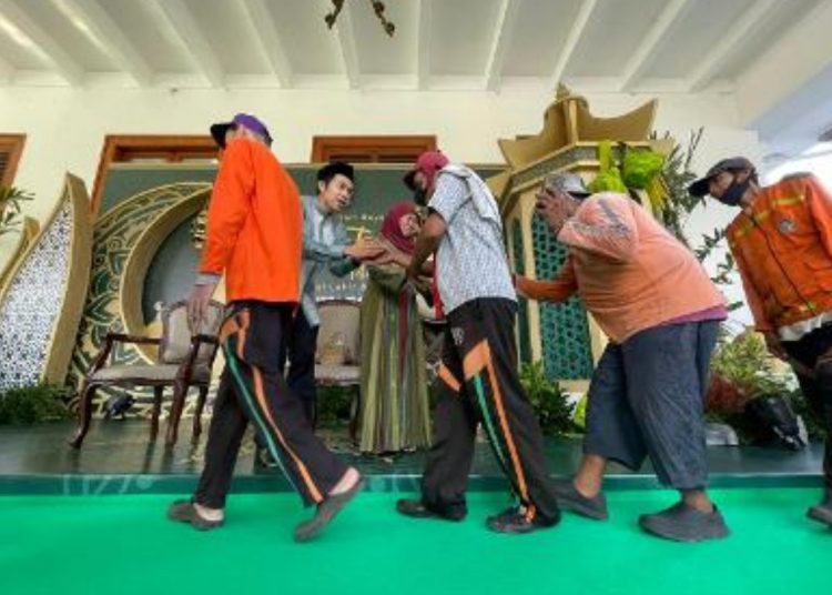 Gubernur Jatim Khofifah Indar Parawansa bersama sang putra kedua Jalaluddin menyalami warga yang menghadiri open house di gedung negara Grahadi.