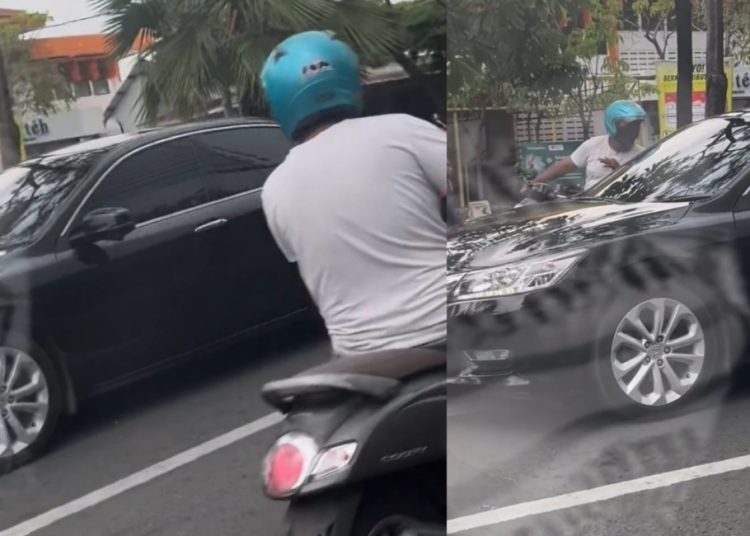 Tangkapan layar video yang beredar di media sosial seorang pengendara motor yang diduga meminta uang kepada pengemudi mobil.