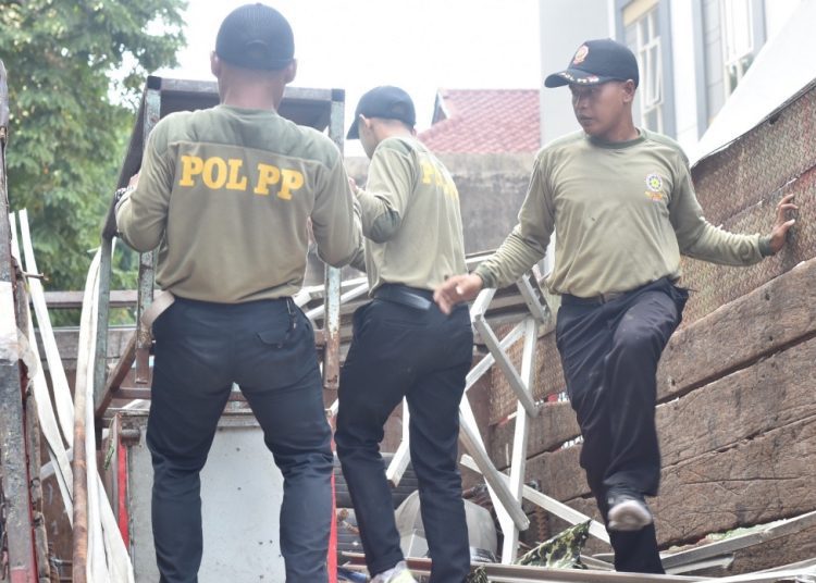 Personel Satpol PP melakukan penertiban bangunan dan pengamanan aset di Jalan Kencanasari Timur, Kelurahan Gunungsari, Kecamatan Dukuh Pakis, Surabaya